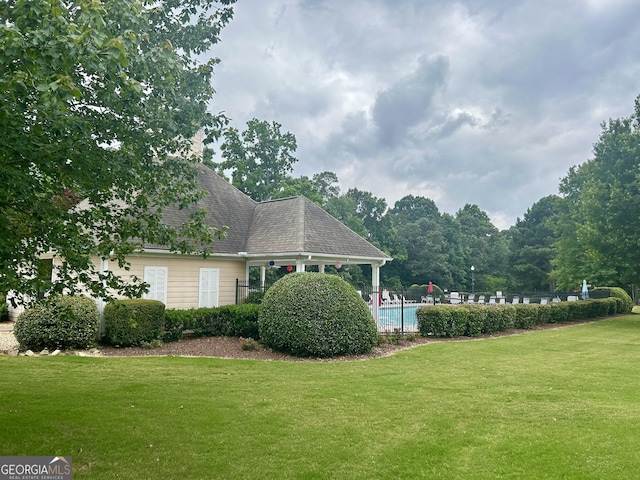 4863 Beacon Ridge Ln, Flowery Branch, GA 30542 - view of property exterior featuring a lawn and a community pool