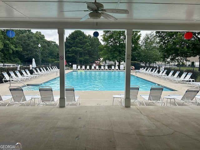 4863 Beacon Ridge Ln, Flowery Branch, GA 30542 - community pool featuring a ceiling fan, a patio area, and view of wooded area
