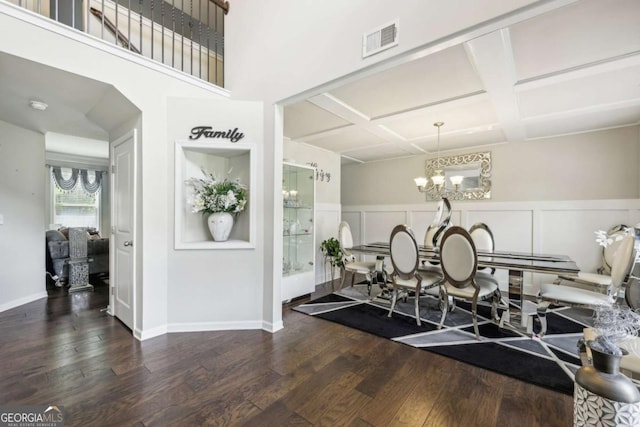 3126 Cove View Ct, Dacula, GA 30019 - dining space with coffered ceiling, wood finished floors, a chandelier, beam ceiling, and a decorative wall