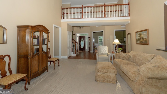 219 Periwinkle Way, Pendergrass, GA 30567 - living room featuring a towering ceiling, baseboards, wood finished floors, and stairway