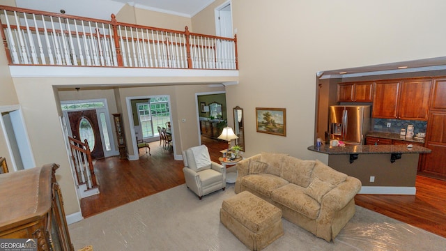 219 Periwinkle Way, Pendergrass, GA 30567 - living area with a towering ceiling, wood finished floors, ornamental molding, and baseboards