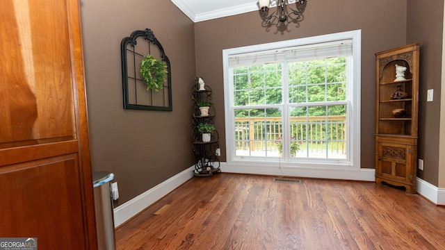 219 Periwinkle Way, Pendergrass, GA 30567 - doorway to outside featuring a chandelier, crown molding, healthy amount of natural light, and baseboards