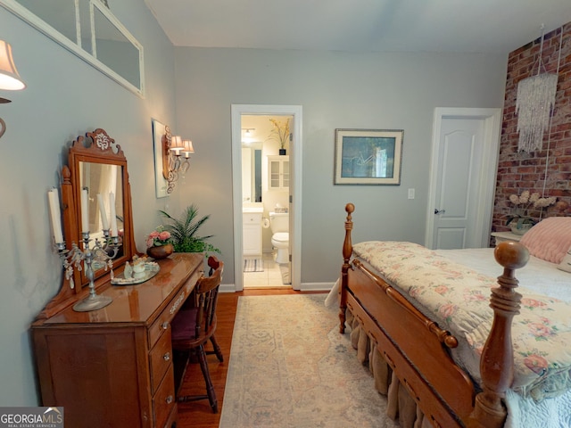219 Periwinkle Way, Pendergrass, GA 30567 - bedroom with wood finished floors, baseboards, and ensuite bathroom