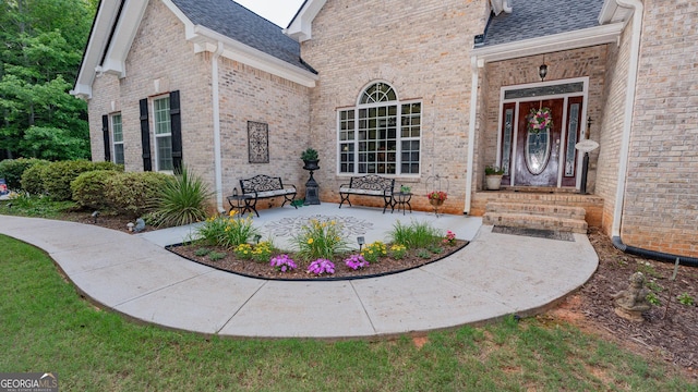 219 Periwinkle Way, Pendergrass, GA 30567 - property entrance featuring a shingled roof and brick siding