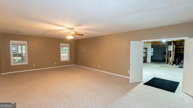 219 Periwinkle Way, Pendergrass, GA 30567 - spare room featuring ceiling fan, light carpet, baseboards, and a textured ceiling