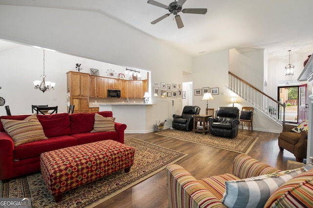 2059 Ivey Chase Dr, Dacula, GA 30019 - living room with high vaulted ceiling, a chandelier, stairs, a ceiling fan, and wood finished floors