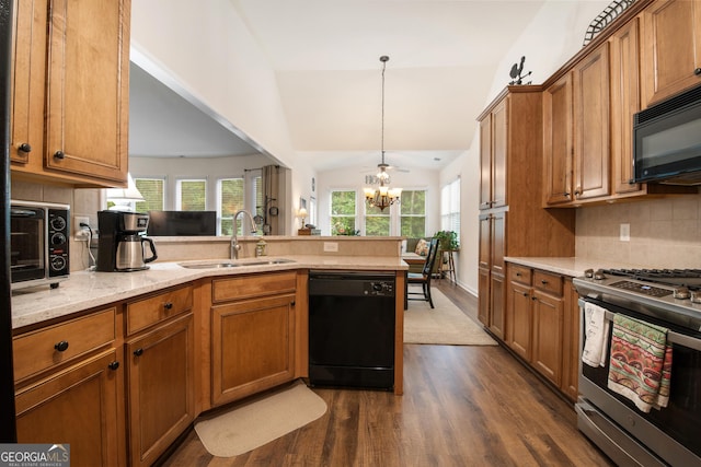 2059 Ivey Chase Dr, Dacula, GA 30019 - kitchen with black appliances, a sink, a peninsula, brown cabinetry, and vaulted ceiling