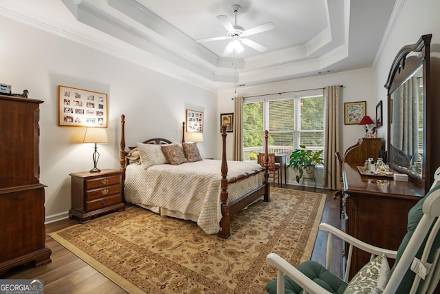 2059 Ivey Chase Dr, Dacula, GA 30019 - bedroom with a raised ceiling, wood finished floors, ornamental molding, ceiling fan, and baseboards