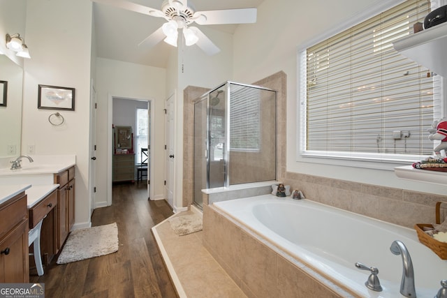 2059 Ivey Chase Dr, Dacula, GA 30019 - full bath featuring vanity, a bath, a shower stall, wood finished floors, and a ceiling fan