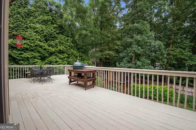 2059 Ivey Chase Dr, Dacula, GA 30019 - wooden deck with outdoor dining area and view of wooded area