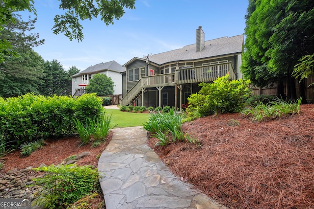 2059 Ivey Chase Dr, Dacula, GA 30019 - back of property with stairway, a wooden deck, and a chimney