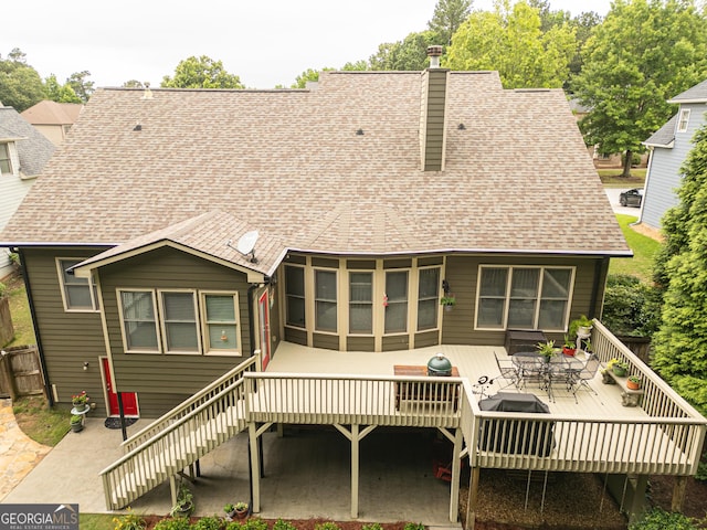2059 Ivey Chase Dr, Dacula, GA 30019 - back of property with a deck, roof with shingles, a chimney, stairs, and outdoor dining area
