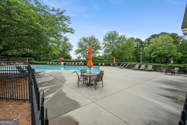2059 Ivey Chase Dr, Dacula, GA 30019 - community pool featuring a patio and view of wooded area