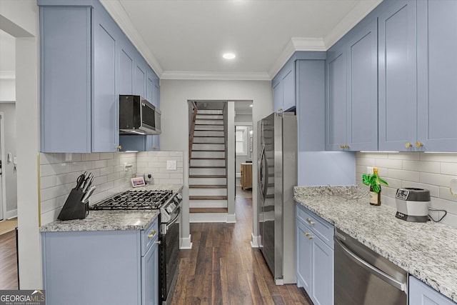 528 Allendale Dr, Decatur, GA 30032 - kitchen featuring appliances with stainless steel finishes, ornamental molding, dark wood-style flooring, baseboards, and light stone counters