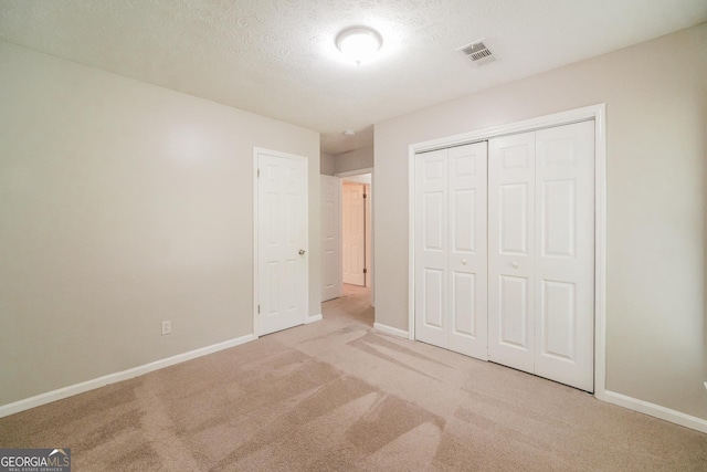 113 Lisa Ln, Carrollton, GA 30117 - unfurnished bedroom featuring carpet, baseboards, a closet, and a textured ceiling