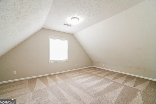 113 Lisa Ln, Carrollton, GA 30117 - additional living space featuring light carpet, lofted ceiling, baseboards, and a textured ceiling