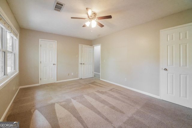 113 Lisa Ln, Carrollton, GA 30117 - unfurnished bedroom with light colored carpet, baseboards, and ceiling fan