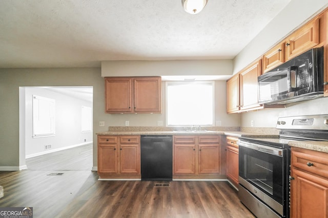 113 Lisa Ln, Carrollton, GA 30117 - kitchen featuring electric stove, dishwashing machine, black microwave, a sink, and light countertops