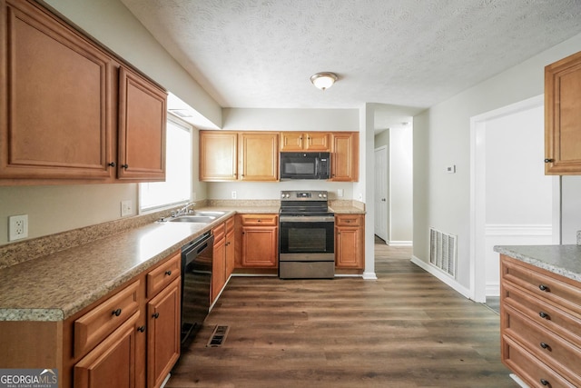 113 Lisa Ln, Carrollton, GA 30117 - kitchen featuring black appliances, a sink, dark wood finished floors, baseboards, and a textured ceiling