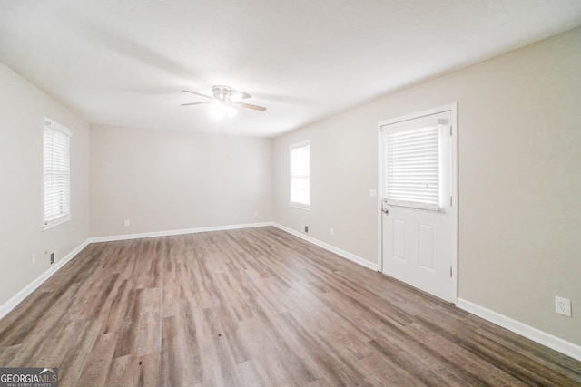 113 Lisa Ln, Carrollton, GA 30117 - empty room with a ceiling fan, wood finished floors, and baseboards