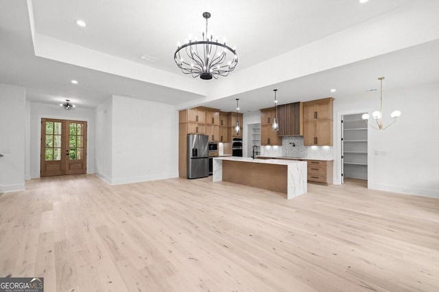 83 Beech Creek Cir, Winder, GA 30680 - kitchen featuring a chandelier, stainless steel fridge with ice dispenser, open floor plan, a sink, and light wood-style floors