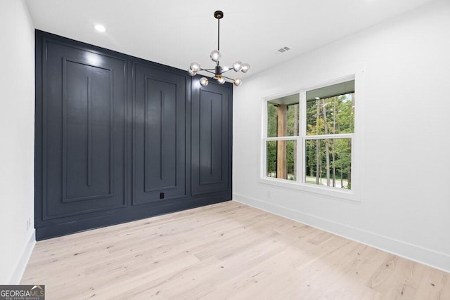 83 Beech Creek Cir, Winder, GA 30680 - unfurnished room with a chandelier, light wood-style floors, and baseboards