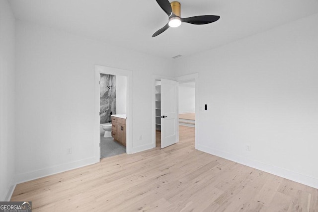 83 Beech Creek Cir, Winder, GA 30680 - unfurnished bedroom with light wood finished floors, baseboards, ensuite bathroom, and a walk in closet