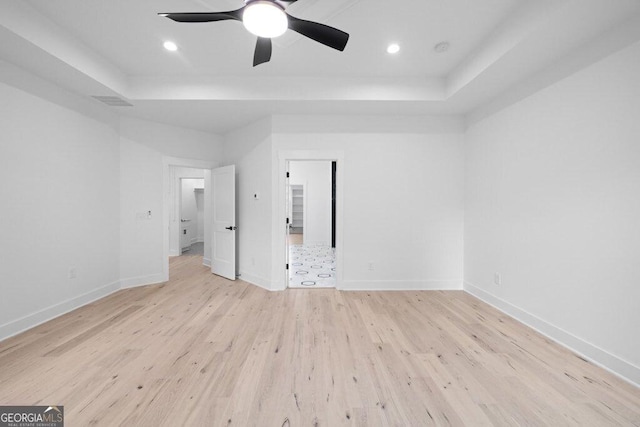 83 Beech Creek Cir, Winder, GA 30680 - spare room featuring a tray ceiling, light wood-style flooring, baseboards, ceiling fan, and recessed lighting