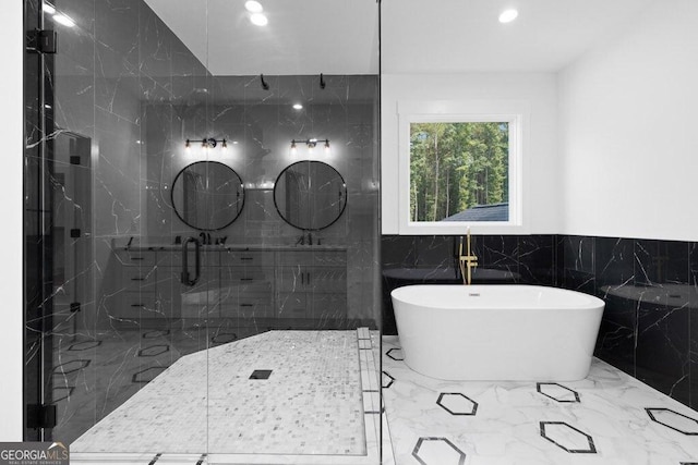 83 Beech Creek Cir, Winder, GA 30680 - bathroom with a freestanding tub, a marble finish shower, recessed lighting, marble tiled flooring, and a wainscoted wall