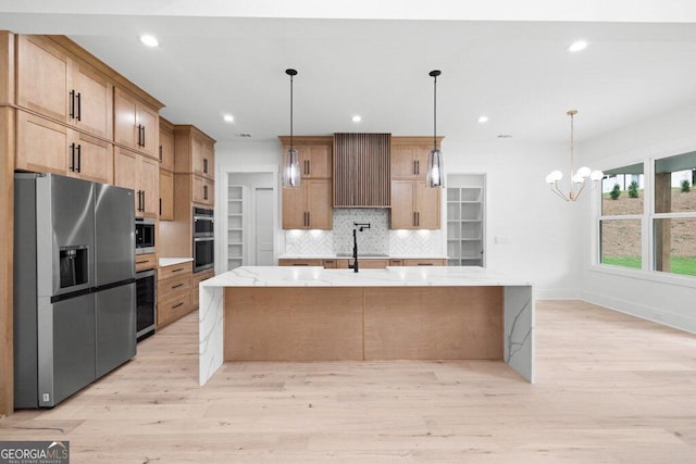 83 Beech Creek Cir, Winder, GA 30680 - kitchen with appliances with stainless steel finishes, tasteful backsplash, light wood-style floors, a large island, and recessed lighting