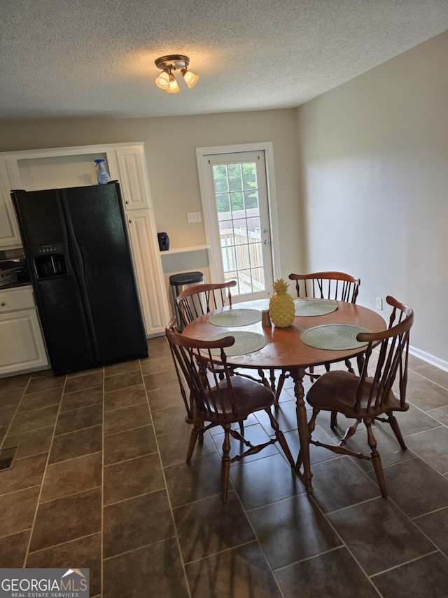 1214 Tucker Rd, Perry, GA 31069 - dining room with dark tile patterned flooring and a textured ceiling