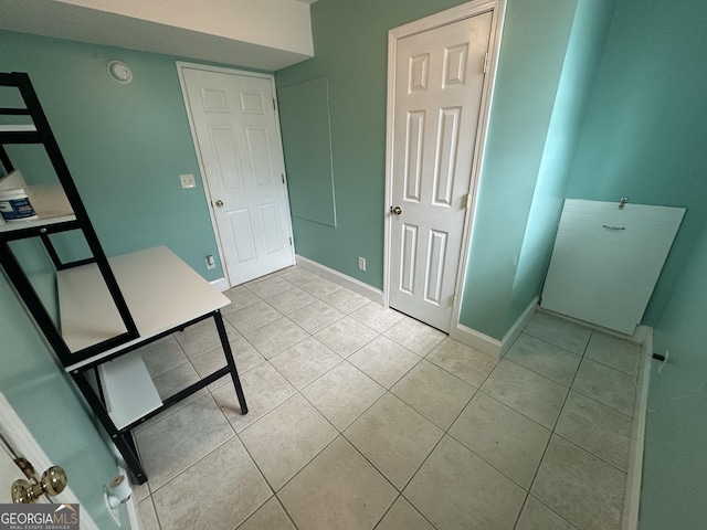 1214 Tucker Rd, Perry, GA 31069 - unfurnished bedroom with light tile patterned floors and baseboards