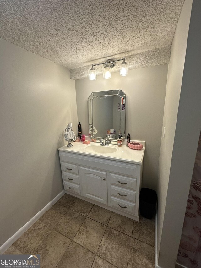 1214 Tucker Rd, Perry, GA 31069 - bathroom with vanity, a textured ceiling, and tile patterned floors