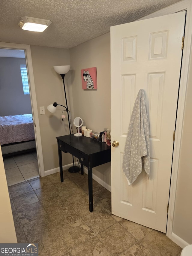 1214 Tucker Rd, Perry, GA 31069 - ensuite bathroom with a textured ceiling and baseboards