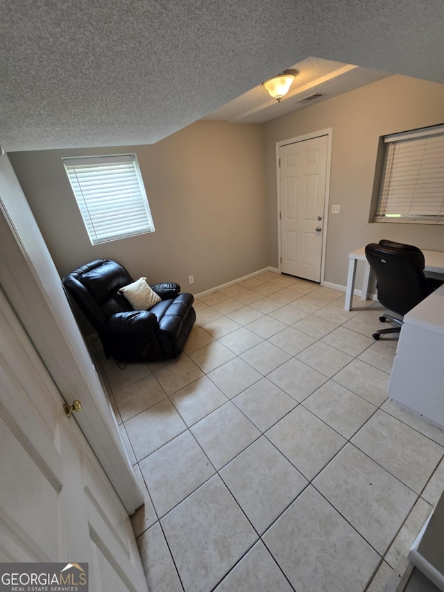 1214 Tucker Rd, Perry, GA 31069 - foyer featuring a textured ceiling, light tile patterned flooring, and baseboards