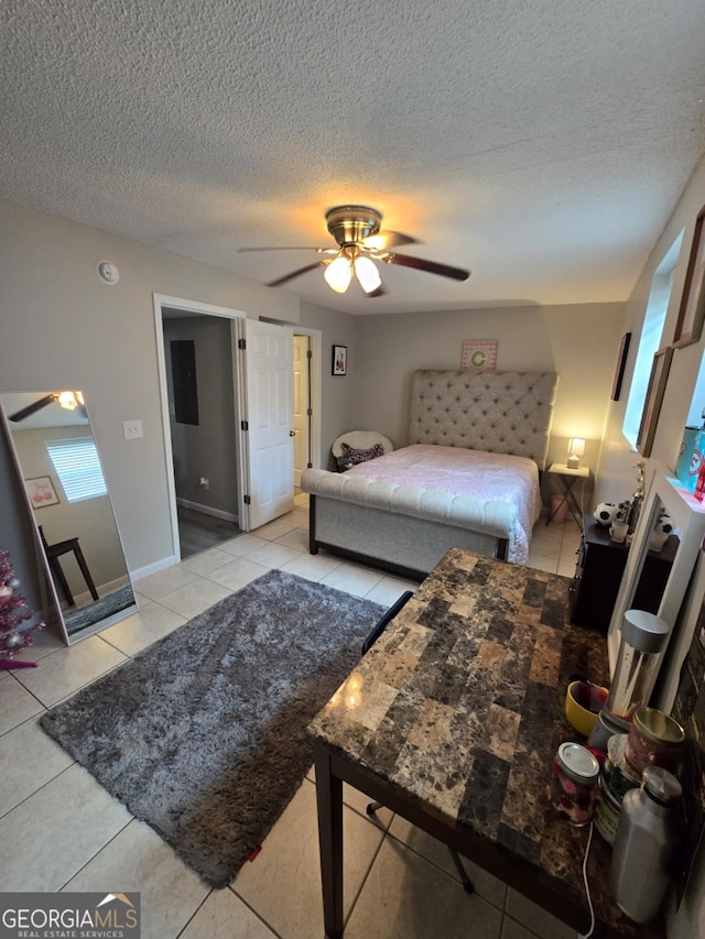 1214 Tucker Rd, Perry, GA 31069 - tiled bedroom featuring a textured ceiling and ceiling fan