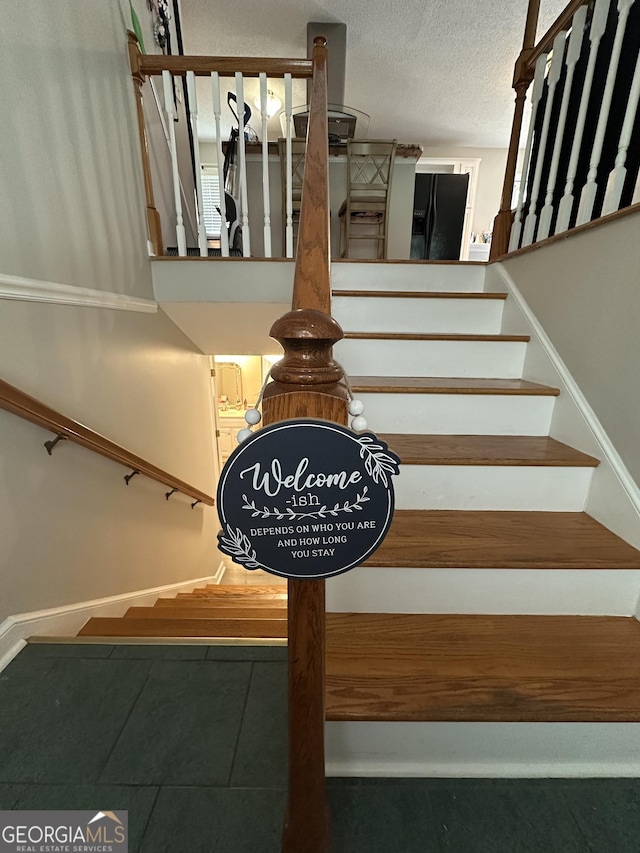 1214 Tucker Rd, Perry, GA 31069 - stairway with tile patterned floors, baseboards, and a textured ceiling