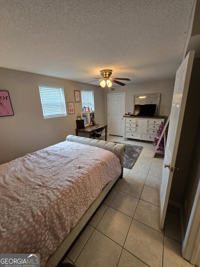 1214 Tucker Rd, Perry, GA 31069 - bedroom with light tile patterned flooring, a textured ceiling, and ceiling fan