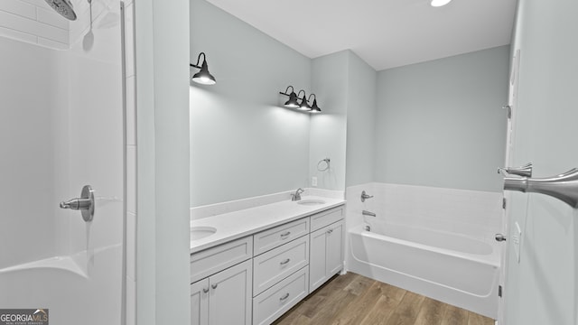 5016 Smith Rd SE, Townsend, GA 31331 - bathroom featuring wood finished floors, a bath, double vanity, and a shower