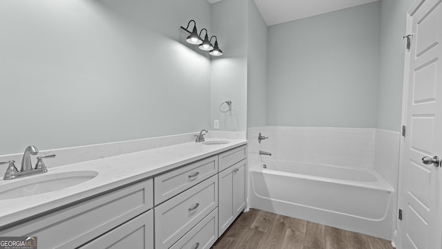 5016 Smith Rd SE, Townsend, GA 31331 - bathroom featuring a bath, wood finished floors, and double vanity