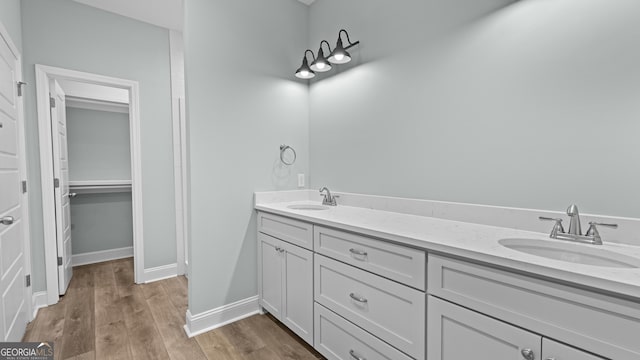 5016 Smith Rd SE, Townsend, GA 31331 - full bathroom featuring double vanity, wood finished floors, and baseboards