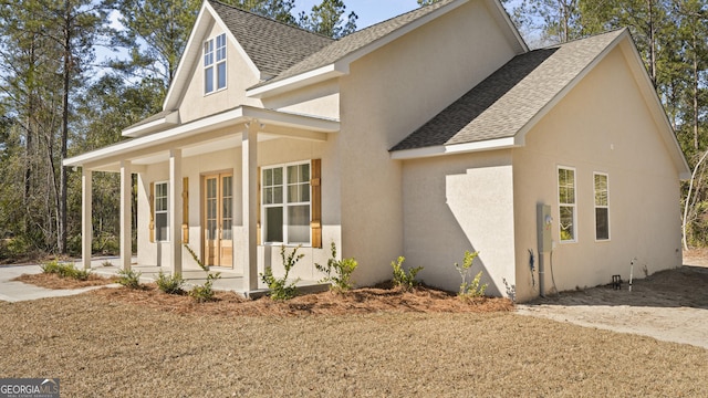5016 Smith Rd SE, Townsend, GA 31331 - view of home's exterior with a shingled roof, covered porch, and stucco siding