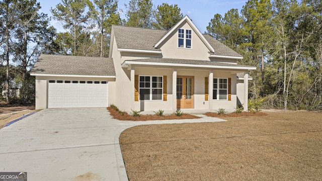 5016 Smith Rd SE, Townsend, GA 31331 - view of front of property featuring concrete driveway, a garage, stucco siding, a shingled roof, and a porch