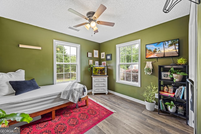301 Bradford Ct, Auburn, GA 30011 - bedroom featuring wood finished floors, a textured ceiling, baseboards, and ceiling fan