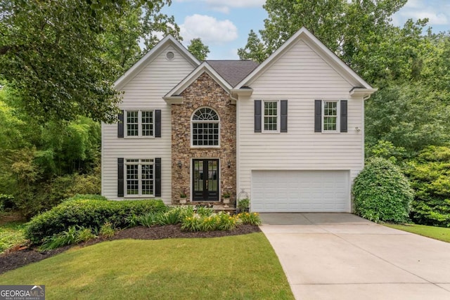 3801 Stonebriar Ln, Duluth, GA 30097 - traditional-style house with a garage, driveway, a front yard, stone siding, and french doors