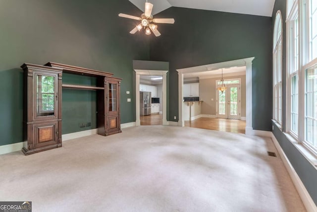 3801 Stonebriar Ln, Duluth, GA 30097 - unfurnished living room featuring high vaulted ceiling, light colored carpet, baseboards, ceiling fan, and a chandelier