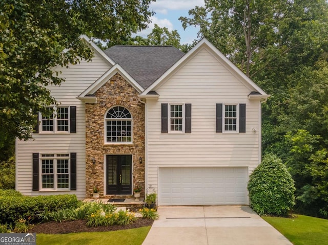 3801 Stonebriar Ln, Duluth, GA 30097 - view of front of property featuring an attached garage, driveway, stone siding, french doors, and roof with shingles