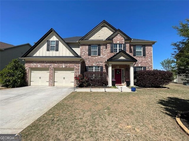 2030 Hydrangea Ln, Austell, GA 30106 - view of front of house featuring brick siding, concrete driveway, board and batten siding, and a front lawn
