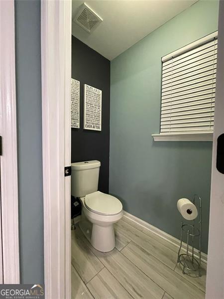 2030 Hydrangea Ln, Austell, GA 30106 - bathroom with wood tiled floors and toilet
