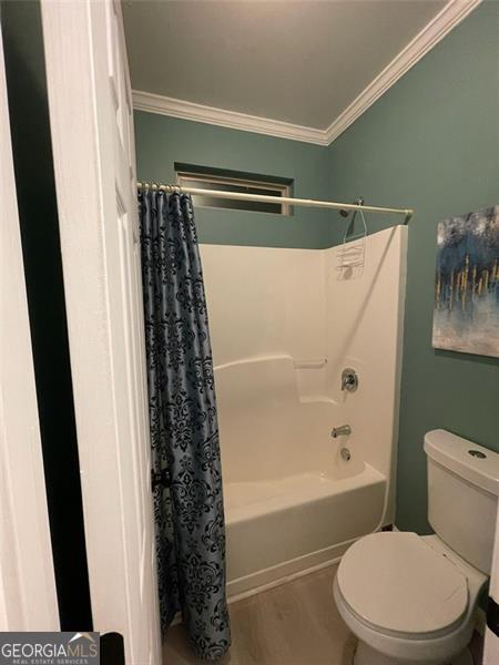 2030 Hydrangea Ln, Austell, GA 30106 - full bath featuring ornamental molding, shower / bath combo with shower curtain, and wood finished floors